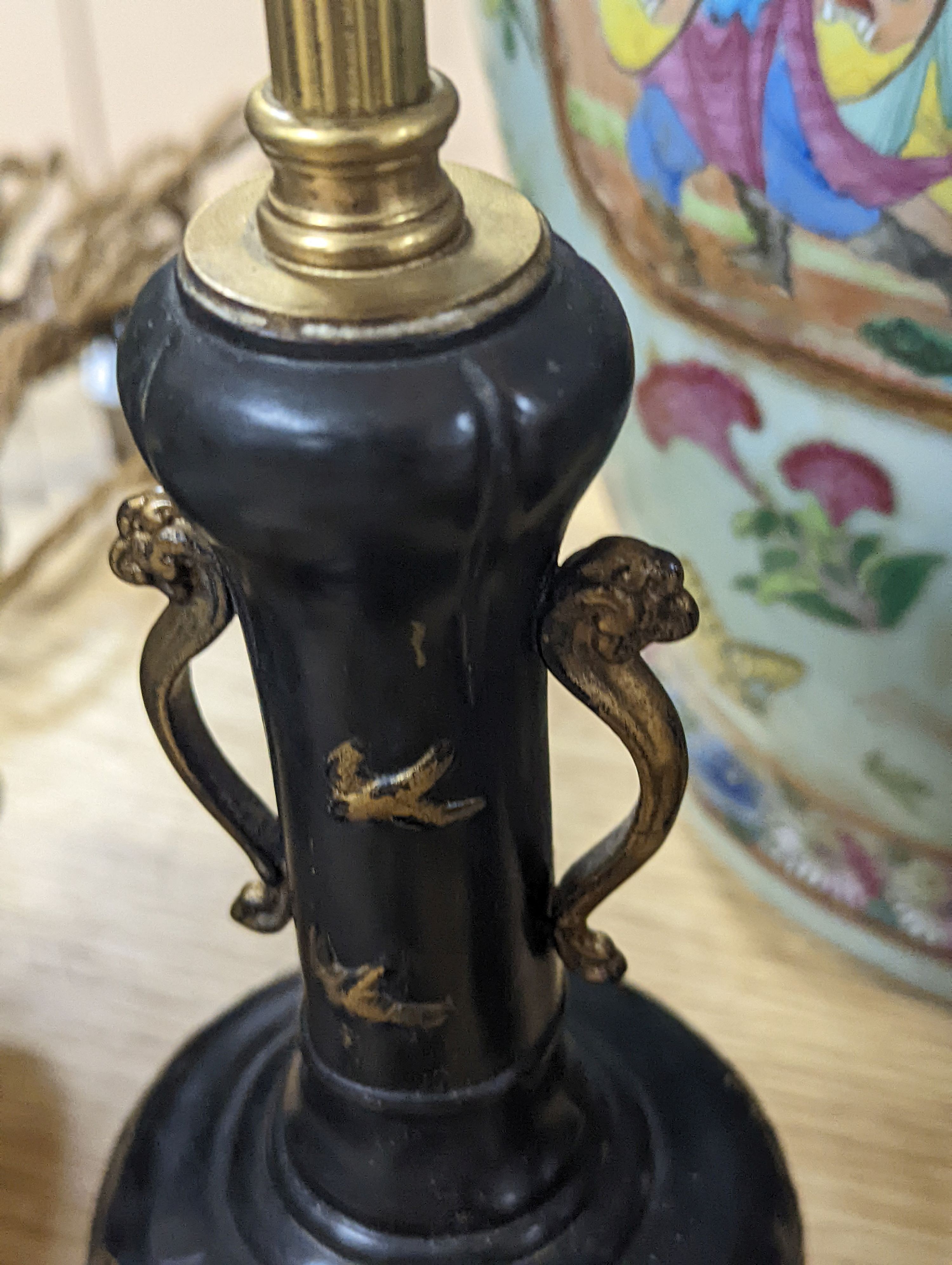 A decorative scroll brass inkstand, together with a pair of lamps, 29cm tall, (3)